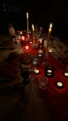 the table is set with candles and dishes