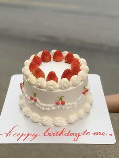 a birthday cake with strawberries on top