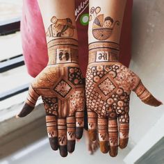 two hands with hendi designs on them