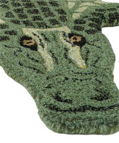 a green rug with an animal's face on it