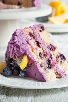 a piece of cake with blueberries and lemon wedges