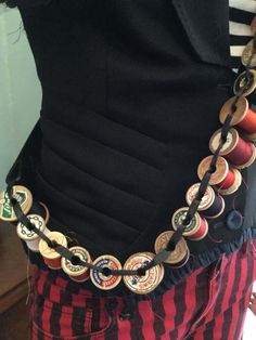 the belt is adorned with many different buttons on it's waist and has an attached chain