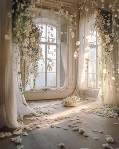 a room filled with lots of white flowers and petals on the floor next to two windows