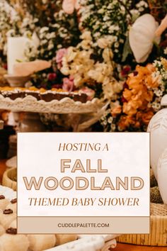 fall woodland themed baby shower with lots of flowers and cookies on the table in front of it