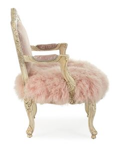 an antique chair with pink fur on it