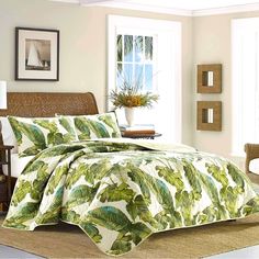 a bed covered in a green and white comforter