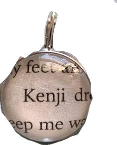 a silver pendant with words written on it