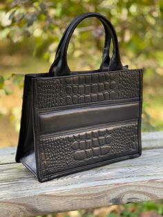 "Women's handcrafted Small Tote and Cross-body bag, perfect for everyday life or travel in style, made of cow-hide leather simulating crocodile pattern, very classic design, fits all your basics and more. Beautiful leather simulating crocodile pattern Inside features one zip pocket, one-slide pocket in one side, and two-slide pockets in the other Adjustable Removable Leather Strap 40\" long Measurements 11\" L x 18.5\"H x 4.5' D Zip Closure Cow-hide Leather Imported from Mexico Handcrafted Perfe Leather Bag Pattern, Pattern Bag, Crocodile Pattern, Travel In Style, Crocodile Leather, Cow Hide, Leather Pattern, Small Tote, Weekend Getaways