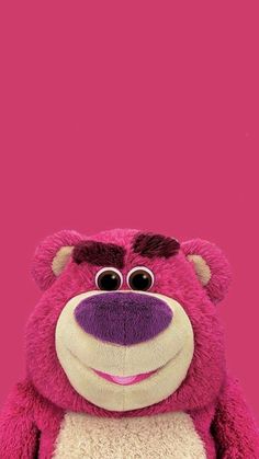 a pink teddy bear with big eyes and a smile on it's face, standing in front of a pink background