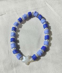 Cute blue and white beaded bracelet. These are high quality handmade bracelets. They are made with an very stretchy and strong elastic string so will fit lots of sizes. They are around 6.75 inches. Please note that each braclet will have a very similar beading pattern but not exactly identical. Blue Handmade Star-shaped Beaded Bracelets, Blue Beaded Star-shaped Bracelets, Handmade Blue Star Bracelet, Handmade Blue Star-shaped Bracelet, White Star-shaped Bracelet With Colorful Beads, Doctor Who Jewelry, Bracelet Clay, Clay Beaded Bracelet, Make Clay Beads