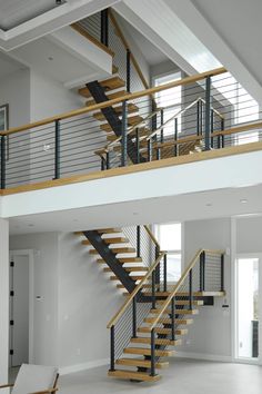 a large open floor plan with stairs and railings