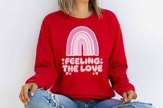 This sweatshirt is the perfect addition to your Valentine's Day wardrobe! The vibrant pink boho rainbow design is both playful and stylish, and the message "feeling the love" perfectly captures the sentiment of the holiday. This sweatshirt would make a great gift for a loved one, or you could treat yourself to a little Valentine's Day indulgence. Show off your love for the holiday and for fashion with this trendy and heartfelt sweatshirt! #valentinesdayaesthetic #valentinesdayshirts Valentines Day Outfits Casual, Pink Boho Rainbow, Sweatshirts Aesthetic, Mother Daughter Shirts, Black Women Dress, Toddler Valentines, Daughters Shirt, Christian Sweatshirt, Sweatshirt Outfit