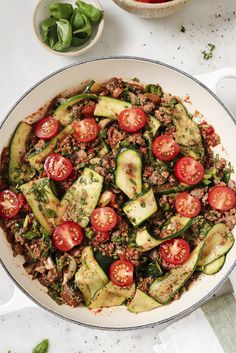 a pan filled with meat and vegetables on top of a table