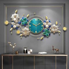 a wall clock with flowers on it in a room next to a table and sideboard