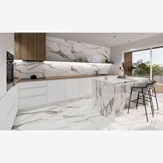 a modern kitchen with marble counter tops and white cabinets, along with bar stools