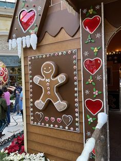 a gingerbread house is decorated with hearts and other holiday decorations for the holiday season