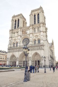 people are standing in front of the cathedral