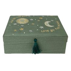 a green box with stars and moon designs on it