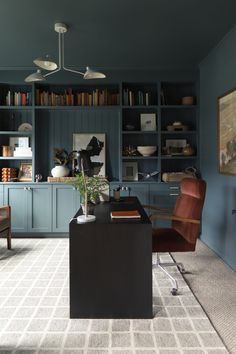 a living room filled with furniture and bookshelves next to a dining room table