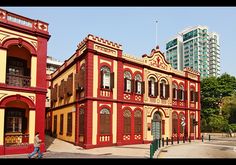 an old red and yellow building in the city