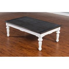 a white coffee table sitting on top of a hard wood floor