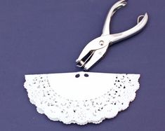 a pair of scissors with white lace on them