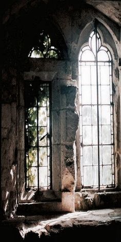 an old stone building with two large windows