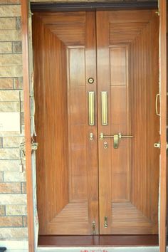 two wooden doors with metal handles on each side