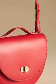 This one is a keeper: Elodie by Clare V. is the perfect size for carrying the essentials, featuring a top handle and removable crossbody strap. | Elodie Crossbody Bag by Clare V. in Red, Women's, Leather at Anthropologie Leather Saddle Bag With Adjustable Handle, Classic Bags With Adjustable Round Handle, Red Flap Bag With Detachable Handle For Travel, Classic Bag With Adjustable Round Handle, Saddle Bag With Detachable Strap For Everyday Use, Red Top Handle Flap Bag With Detachable Handle, Everyday Saddle Bag With Detachable Strap And Top Handle, Classic Bag With Adjustable Strap And Round Handle, Classic Satchel With Adjustable Strap And Round Handle