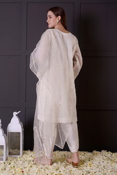 White organza kurta with zari and thread embroidery. Comes with modal satin dhoti pant and a dupatta. - Aza Fashions Traditional Drape Kurta In Organza With Cutdana, Traditional Drape Organza Kurta With Cutdana, Organza Churidar With Dabka In Traditional Drape, Organza Straight Kurta With Gota Work, Organza Kurta With Gota Work In Traditional Drape, Traditional Organza Kurta With Gota Work, Eid Organza Kurta With Gota Work, Straight Kurta In Organza For Navratri, Designer Organza Kurta For Navratri