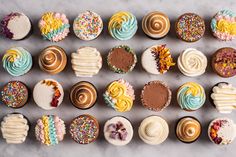 many different types of cupcakes with frosting and sprinkles on them