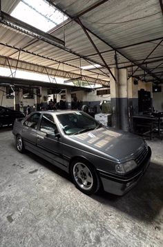 a car is parked in a garage with other cars