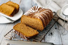 a loaf of pumpkin bread sitting on top of a cooling rack next to a knife