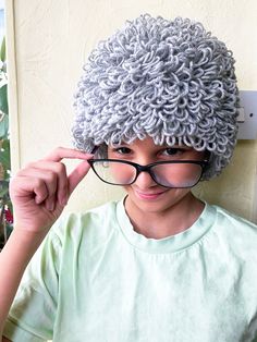 "My Loopy grey crochet curly granny wig is the perfect costume hat for babies, toddlers and children to dress up as a little old lady.  It's a popular choice during the festive season as a Mrs Claus Christmas wig! Choose a different colours instead in  cabbage patch style browns, Raggedy Ann red, natural hair colours for an afro hairstyle, or rainbow for a fun circus clown piece! Girls and boys will love having this beanie to dress up and wear during the winter.  It will also make a memorable bi Old Lady Hair, Red Natural Hair, Grandma Wig, Christmas Wig, Granny Wig, Clown Halloween Costume, Clown Halloween Costumes, Grey Crochet, Lady Hair