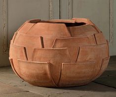 a large clay pot sitting on top of a floor