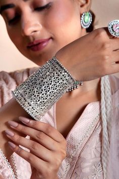 925 sterling silver broad bangle with flower cutwork patterns.
Composition: 925 Sterling Silver
Color: Silver
Other Details: 
Adjustable
Dimension: L x W (in cms): 9.5 x 7
Weight (in gms): 211.58
Note: Earrings and ring worn by the model is not for sale
 - Aza Fashions Fusion Style Bangle Bracelet With Intricate Design, Fusion Style Intricate Bangle Bracelet, Fusion Style Oxidized Finish Bracelets For Wedding, Oxidized Fusion Style Bracelet For Wedding, Fusion Style Oxidized Bracelet For Wedding, Sterling Silver Bracelet With Intricate Design For Wedding, Traditional White Gold Bracelets With Intricate Design, Silver Fusion Style Bangle For Festive Occasions, Traditional White Gold Bracelet With Intricate Design