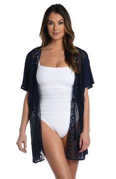 This kimono gets its boho-inspired style from crocheted detailing that lines the front. It's styled with dolman sleeves and a tunnel-tie front that cinches at the waist. Throw it over your suit for a chic cover-up or layer with a cami and a pair of pants for a fashionable finishing touch. [split] Details Kimono cover-up Tunnel-tie front Dolman sleeves Tassel details Lightweight rayon fabric Fabric 100% Rayon Summer Short Sleeve Stretch Cardigan, Open Front Layering Cover-up, Summer Stretch Short Sleeve Cardigan, Stretch Open Front Cardigan For Beach, Fitted Open Front Beach Kimono, Summer Kimono With Lace Trim For Vacation, Fitted Beach Kimono With Kimono Sleeves, Summer Loungewear Cardigan One Size, Summer Vacation Cardigan With Kimono Sleeves