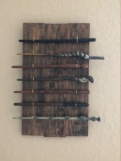 a wooden wall mounted with several different types of umbrellas on it's sides