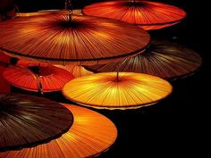 many umbrellas are lit up in the dark