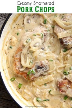 a skillet filled with pasta and meat covered in sauce on top of a wooden table