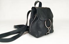 "This is the Mandelyn backpack , handcrafted from top grain Italian soft leather in black colour. A mini size, lightweight backpack with unique surface texture and fascinating design. Dimensions: Height - 23 cm ( 9,05 \") Width - 19/22 cm ( 7,48 \"/ 8,66 \") Depth- 11 cm ( 4,33 \") (depth is measured across bottom of backpack) Key features: * Metal zippers in silver colour from each side of the bag (pics 1 / 3 / 7 ) Exterior features : * Top grain soft Italian leather in black colour * Hardware Handmade Black Backpack For Travel, Handmade Black Travel Backpack, Backpack Purse Leather, Woman Backpack, Leather Backpack Black, Handmade Backpack, Handmade Leather Backpack, Handmade Backpacks, Leather Backpack Purse