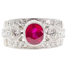 An Art Deco Inspired Engagement, Anniversary or Right Hand Ring is set with a 1.52 Carat Oval Ruby with Rich Red Pink Color Saturation. The Gem Quality stone is set low in the Band Style Ring in a protective bezel of Hand Millegrained White Gold. The Ring is Bezel set with two Round Brilliant Diamonds on either side of the center stone. The two Round Brilliant Diamonds have a combined weight of 0.30 Carat for the pair. The shoulders and sides of the ring are also set with Round Brilliant Diamond Red Pink Color, Right Hand Ring, Ring White Gold, Right Hand Rings, Hand Ring, Engagement Anniversary, Art Deco Inspired, Inspiration Art, Anniversary Ring