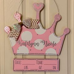 a door hanger with a pink princess crown on it's head and name