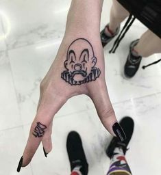 a person's hand with a tattoo on it