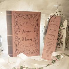 two pink wedding cards on display with ribbons