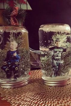 two glass jars with pictures of people in them