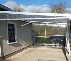 a house with a metal roof and white walls