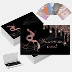 business card with scissors and glitters on the front, in a gift box next to it