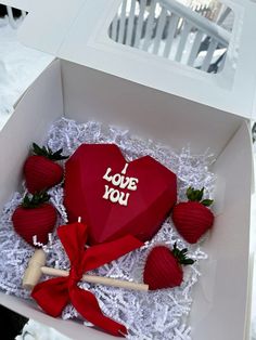 a heart shaped box with strawberries in it