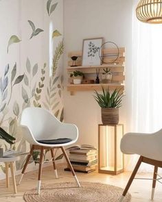 a white chair sitting on top of a hard wood floor next to a wall covered in leaves